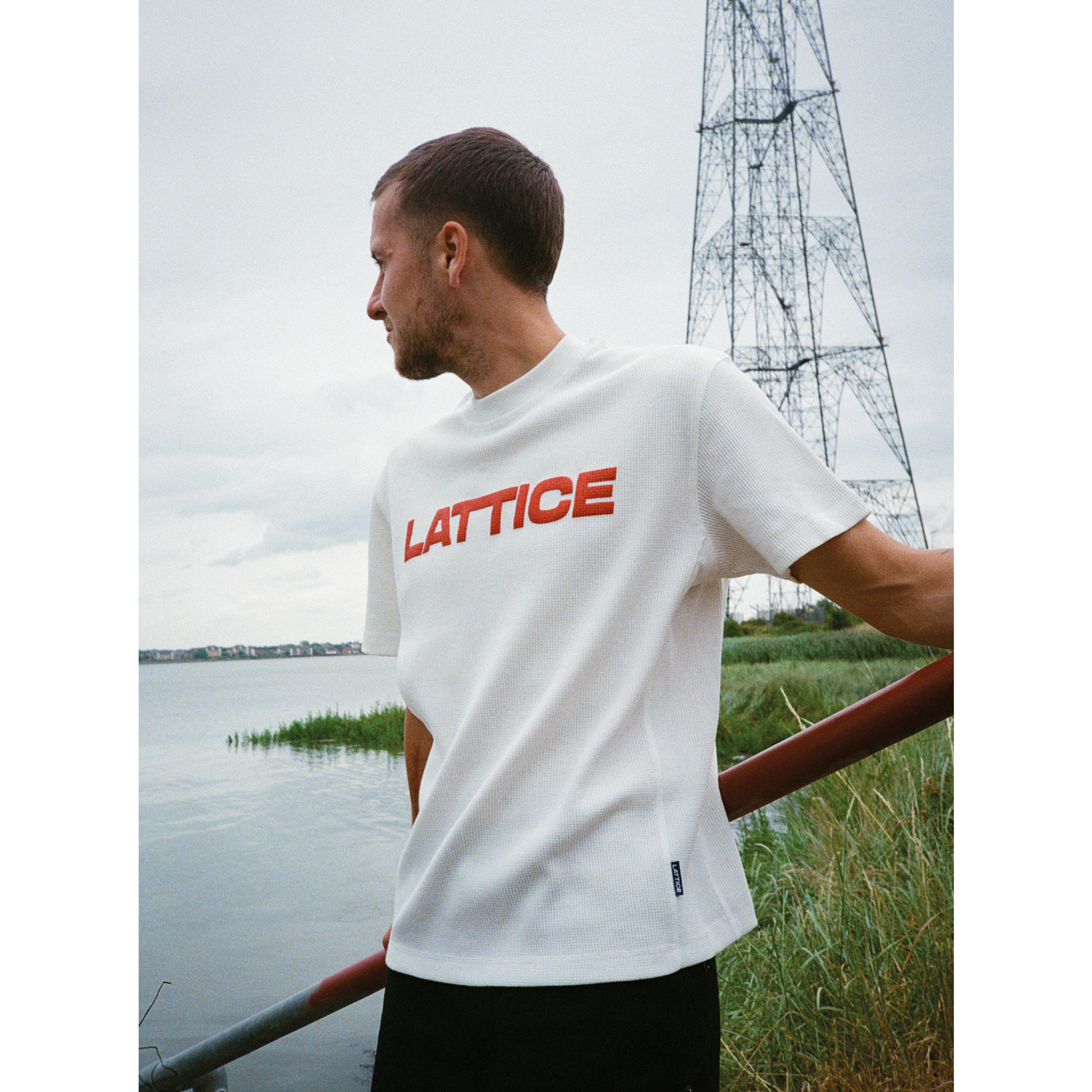 Red lattice graphic tee on white waffle t-shirt, model wearing t-shirt